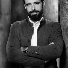 Profile photo of Filippos Lemos, Executive Advisor at Common Seas. Filippos wears a white shirt and dark jacket. He has his arms crossed and is looking at the camera. Photo is in greyscale.