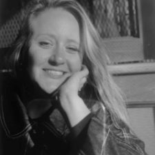 Profile photo of Nicole Dagenais, Designer at Common Seas. Nicole wears a dark knitted jumper. She leans her chin on her hand and smiles at the camera. Photo is in gresyscale.