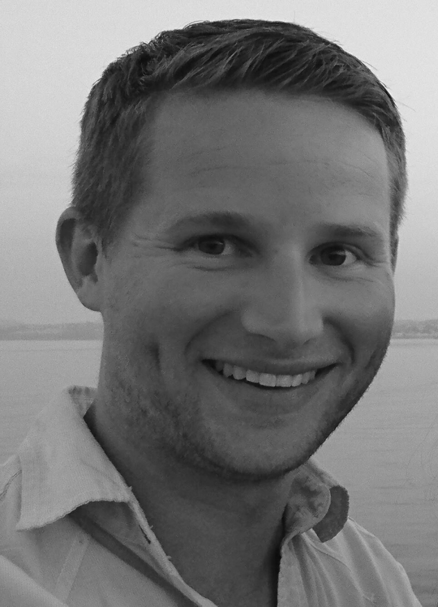 Profile photo of Michael Gerry, Finance Manager at Common Seas. Michael is weather a light-coloured shirt and smiling at the camera. Photo is in greyscale.