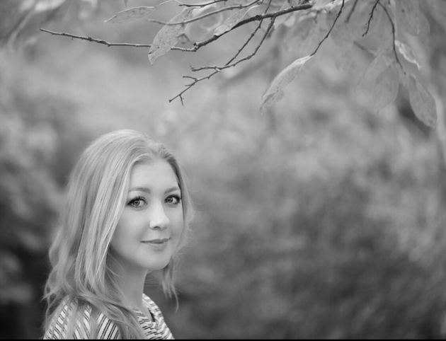 Profile photo of Emma Kai Thomas, Senior Communications Manager at Common Seas. Emma wears a striped jumper and smiles at the camera side-on. Photo is in greyscale.