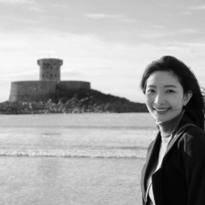 Profile photo of Jiawei Liu, School Engagement Officer at Common Seas. Jiawei is wearing a light-coloured turtle neck and a dark jacket, and smiling at the camera side-on. Photo is in greyscale.