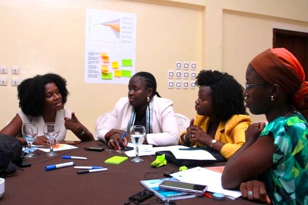 Four women around a table discussing waste flows in Guinea-Bissau