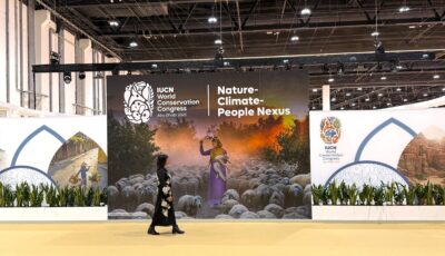 Faryal Gohar at the IUCN World Conservation Congress. Faryal walks in front of a display.