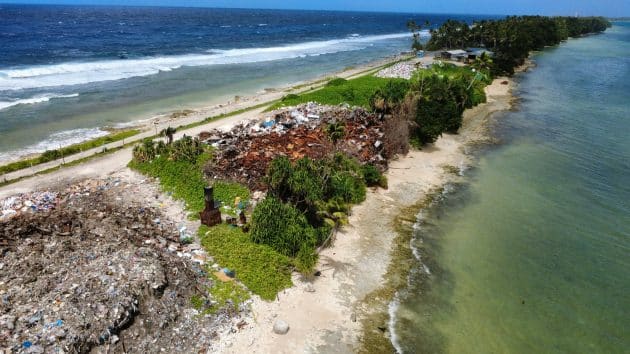 Plastic pollution landfill on narrow strip of land in Tuvalu with sea on either side